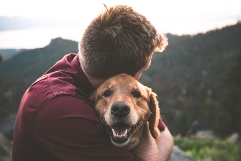 man hugging his pet