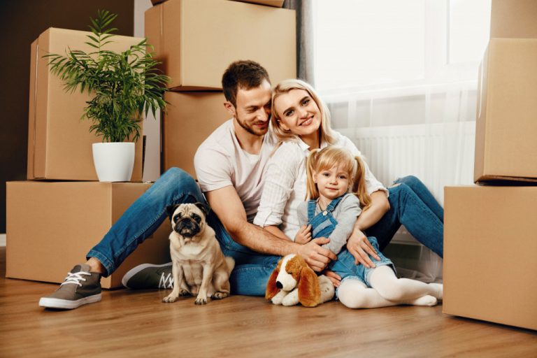 happy family moving into a new home with their pet